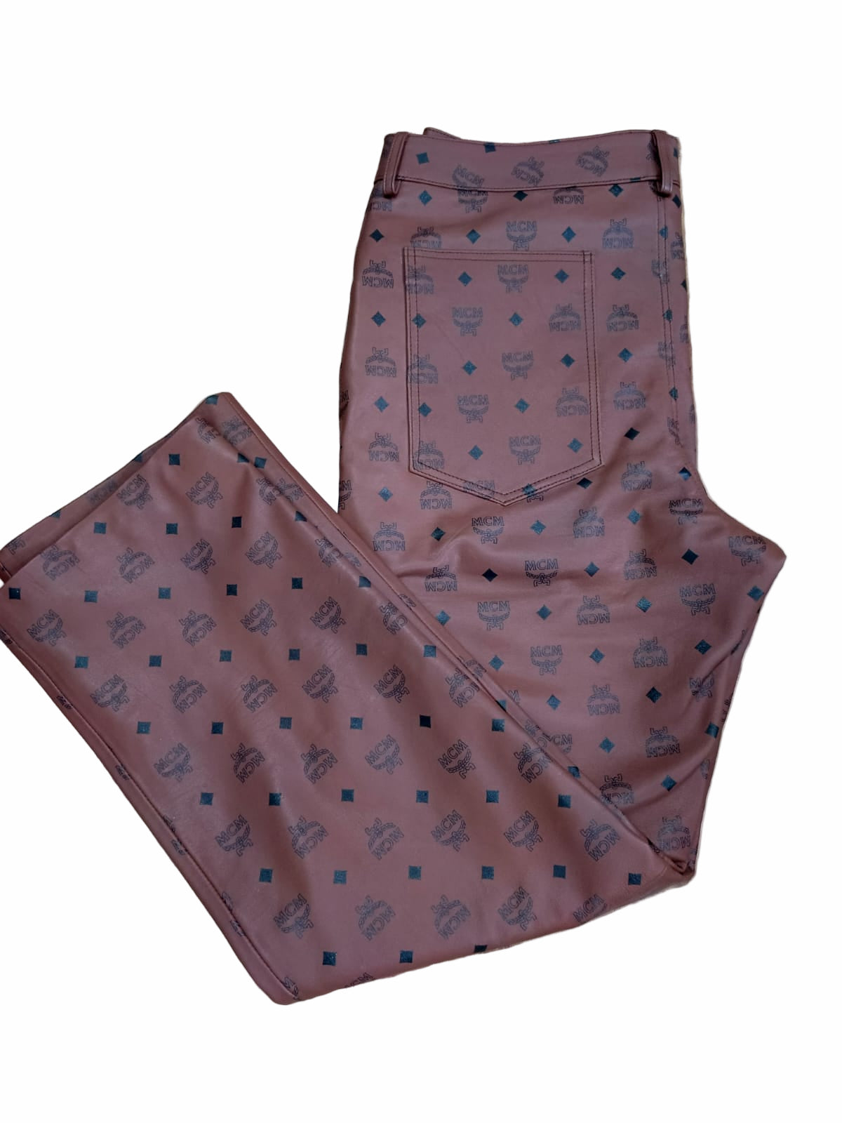 MCM Monogram Leather Pants flat on white background showing back pockets design and belt loops