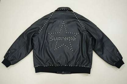 Black studded jacket with a star design on a wooden floor