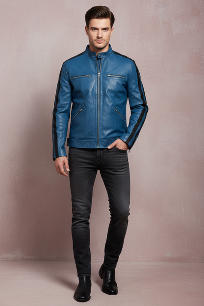 a man wearing a blue cafe racer dirk gently real leather jacket , standing against a light maroon textured wall 