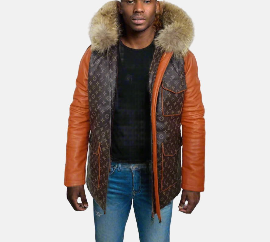 A man wearing a brown Parka leather jacket with a fur hood, paired with a black shirt and blue jeans.