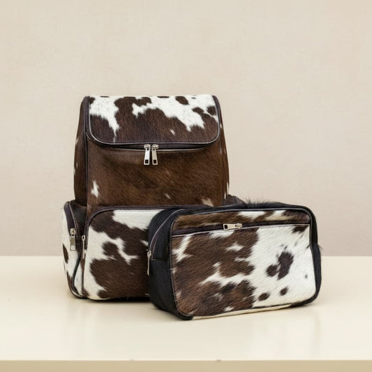 a brown weatern cowhide leather backpack with a tech puch , diapering kit