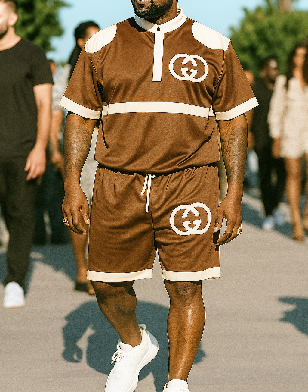Man wearing a brown Gucci tracksuit with sunglasses on a blurred outdoor background