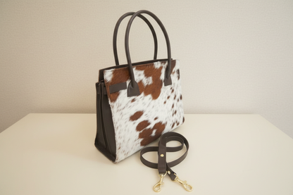 Tote bag with cow print pattern on a white background