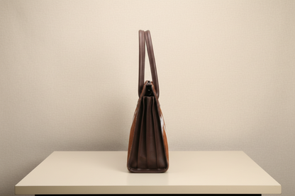 Brown leatehr cowhdie ladies daily handbag with a patterned strap on a white background