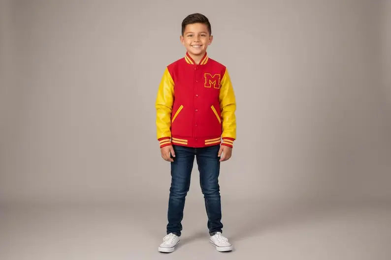 Child wearing a red and yellow varsity jacket with a letter 'M' on a plain background
