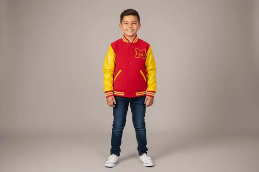 Child wearing a red and yellow varsity jacket with a letter 'M' on a plain background