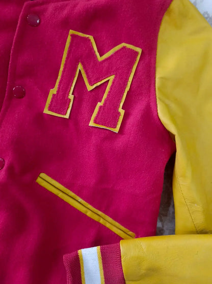 Close-up of a red and yellow letterman jacket with a large 'M' emblem.
