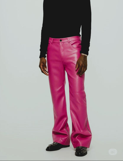 Person wearing a black turtleneck and pink pants on a white background